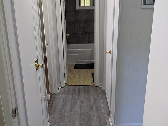 Hallway view from bedroom 1 linen closet on left closet door on right