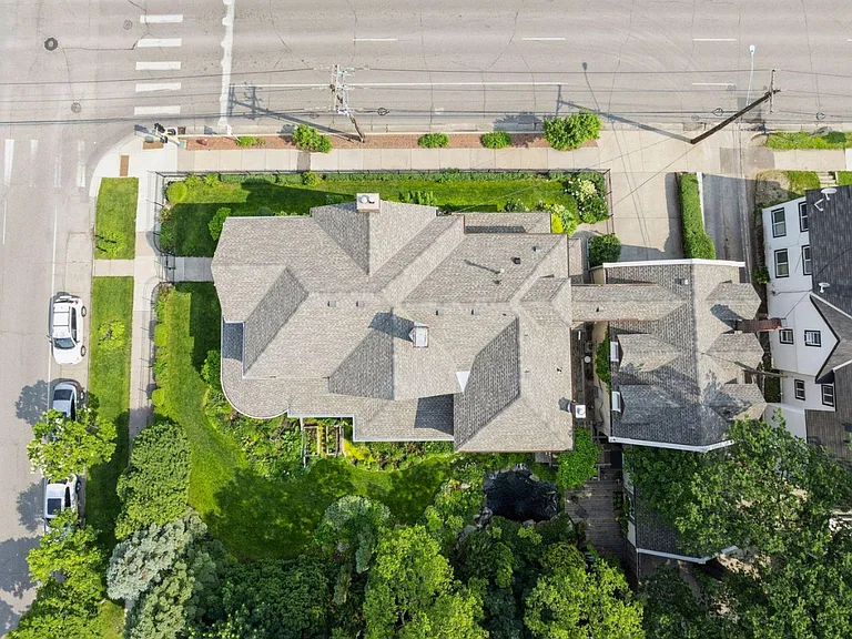 Full ariel view shows carriage house unit to the east of main house. Garage is in the back. Breezeway connects house for access to laundry, storage, and shared entryway with mail/packages.