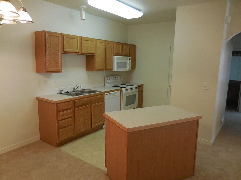 microwave above the stove, refrigerator has an ice maker