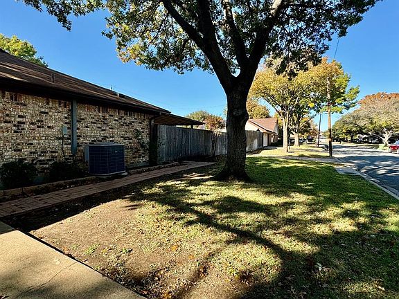 side yard. Big trimmed trees.