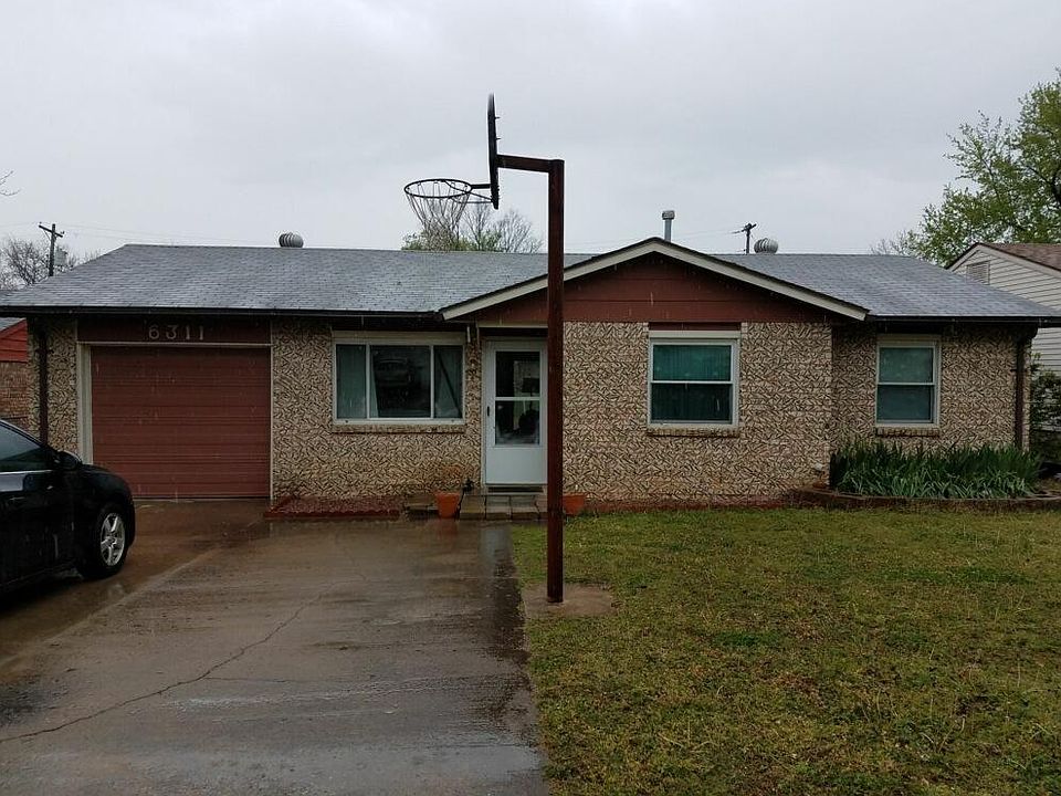 Front of house, large 2 car driveway.  Small storage area in