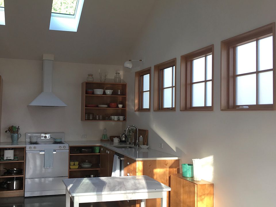 Sleek and charming kitchen with lots of windows and two skyl