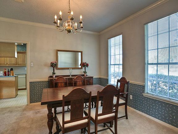 To the right of the entry is this warm dining room with windows facing the front of the home.