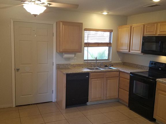 Cozy Kitchen featuring newer appliances and over the range microwave.
