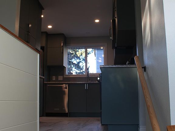 Upstairs, your new home awaits. The kitchen is straight ahead.