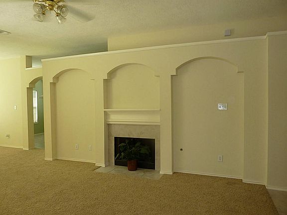 Family room features a gaslog fireplace, plant ledges and gorgeous architectural design