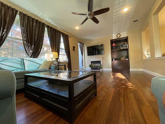 Living Room with large sized Windows, Entertainment Center, Gas Fire place