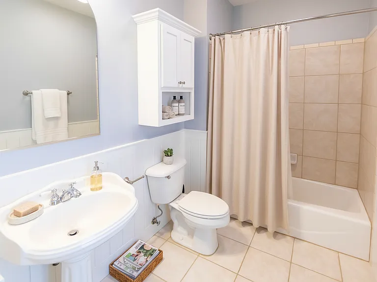The two upstairs bedrooms share this bathroom with a tub.