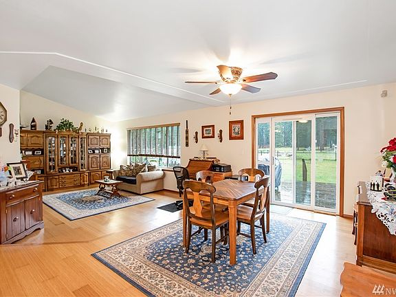 From the front entry, the formal dining and living areas. Great natural light! Coffered ceilings, Bamboo flooring, Slider out tom the deck area.