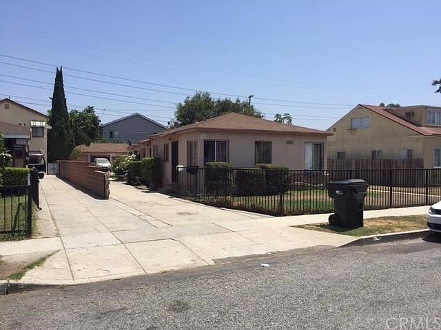 Concrete driveway leads to 4 single car garages