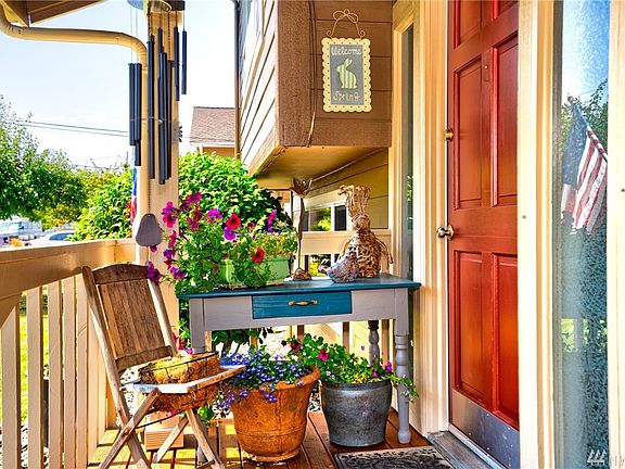 Charming covered entrance sheltered from rain and sun welcomes you home.