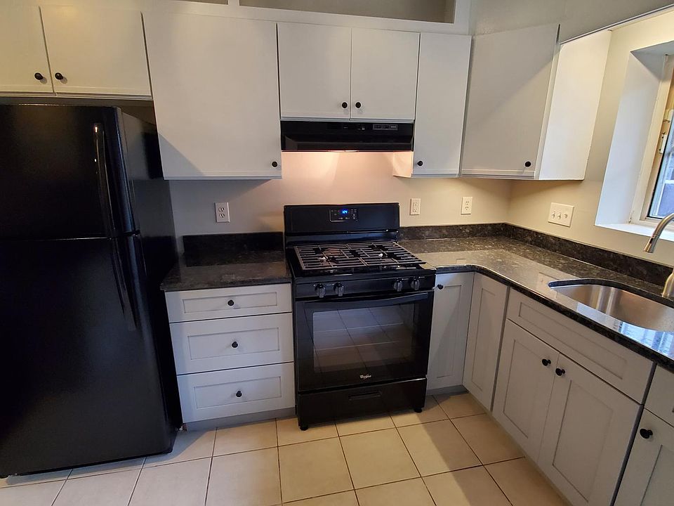 Kitchen with black appliances and granite counters