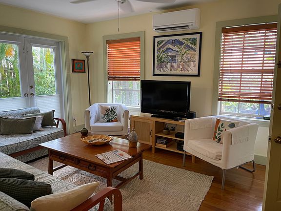 Living room with wood floors, french doors that lead to your outside sitting areas.