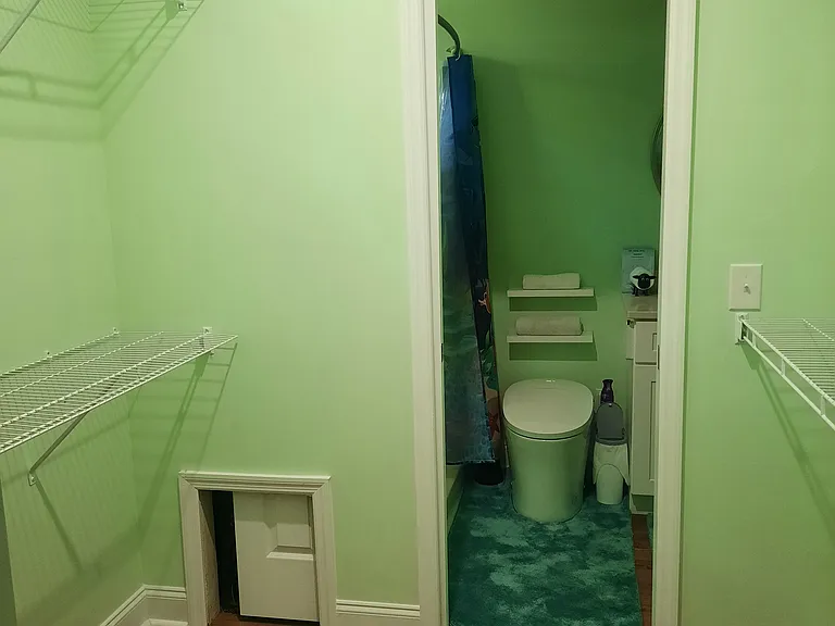 Walk in closet with pocket doors on both sides.