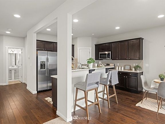 Open kitchen with SS appliances & breakfast bar