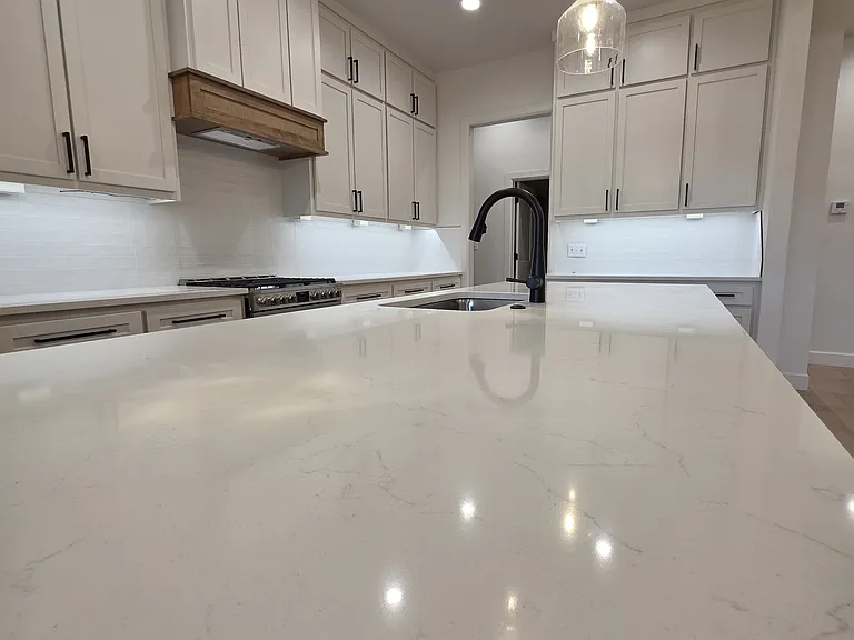 The kitchen features beautiful easy care countertops