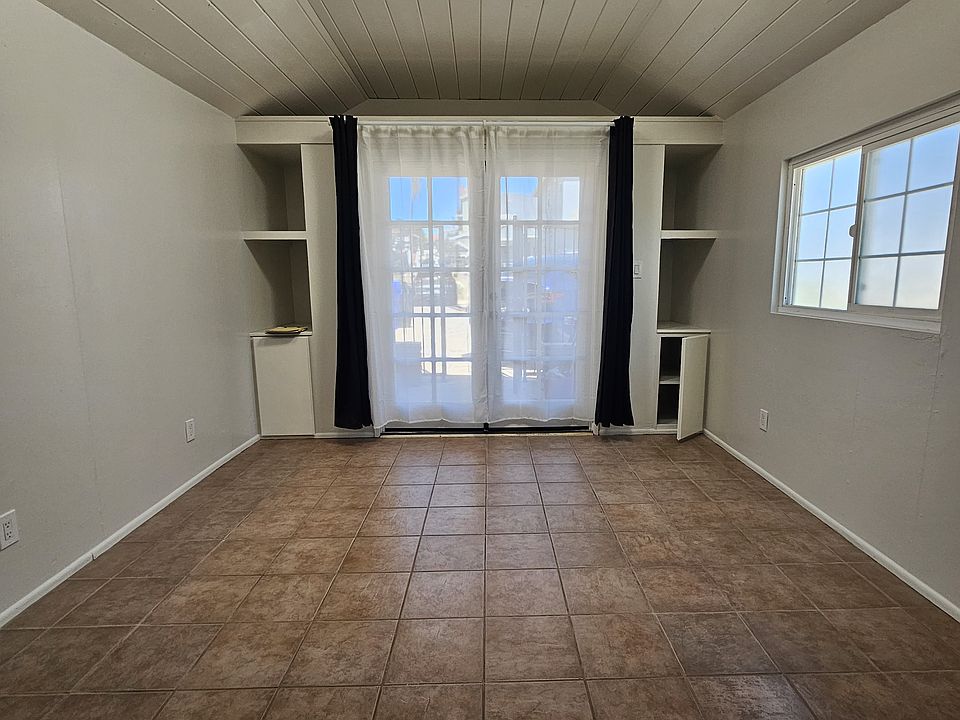 The main living area. There are very deep storage cupboards & shelves. Also a good sized storage loft up above the door.