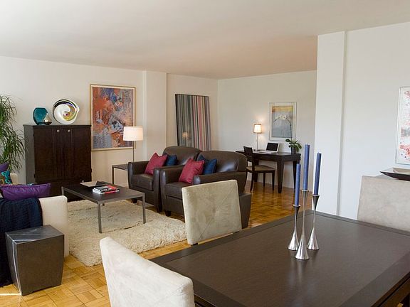 Dining and living area with hardwood flooring