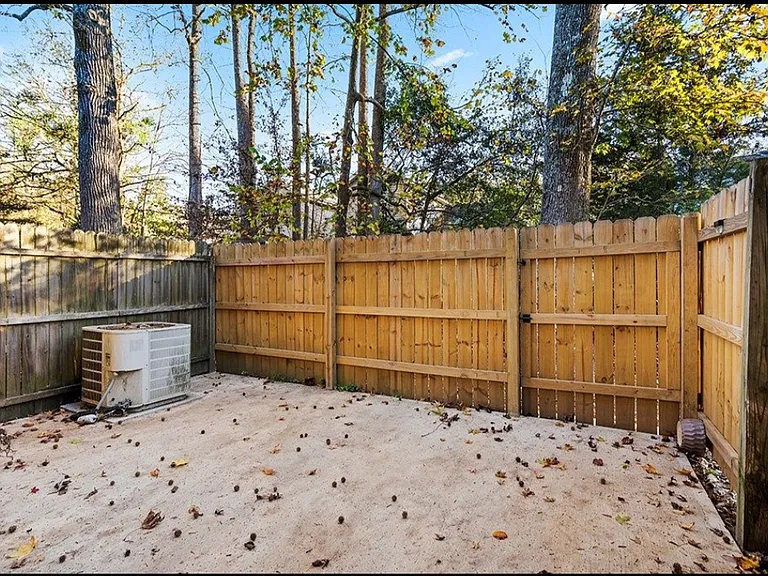 Fenced patio. Table and chairs have been added.