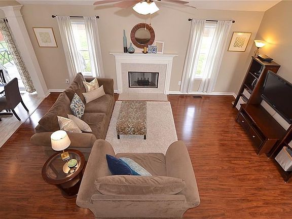 Family can gather around the gas log fireplace and enjoy views of the private backyard.