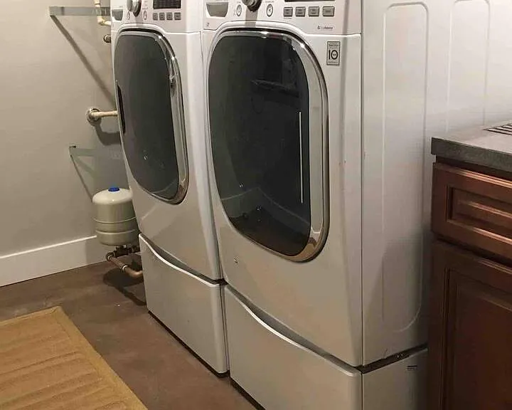 The laundry room has high efficiency, high capacity washer and dryer as well as a utility sink with custom concrete countertop. The laundry room is shared with the upstairs unit.