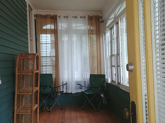 Enclosed front porch is private from street.