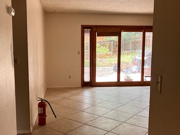 View from entryway/living room to dinning room kitchen and backyard.