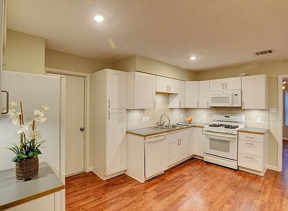 Beautiful, large kitchen with recent cabinets, flooring and lighting.