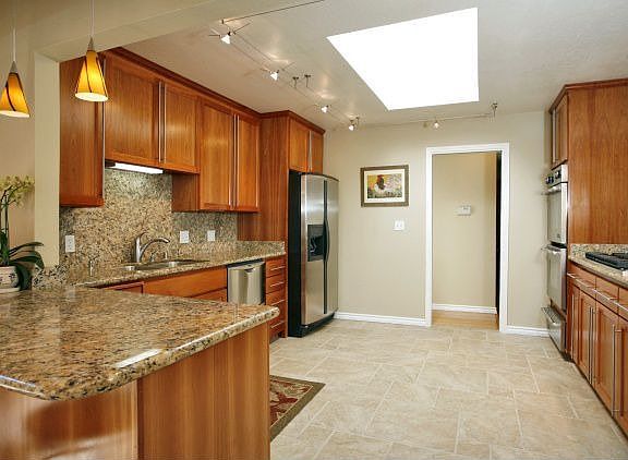 Cherry cabinetry, granite slab, Viking 6 burner gas range