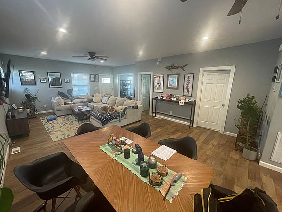 View of Dining Room, Living Room, and doors to guest bathroom and guest bedroom as well as office.