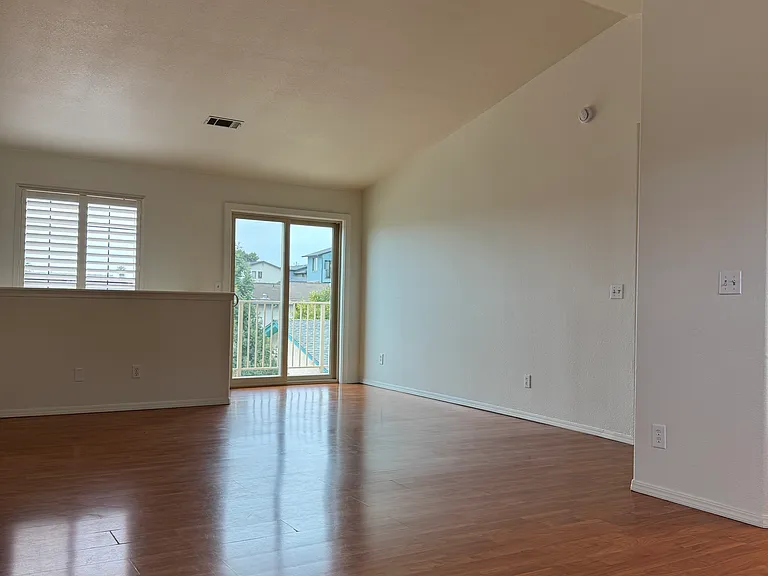Open Concept Living Room/Dining (27' x 17' 6")with Vaulted Ceiling and access to Sun Deck