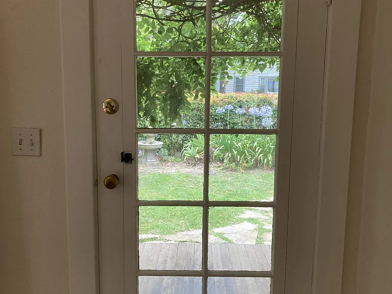 Front door is a "Santa Barbara" door with a swinging window sash over an integrated screen