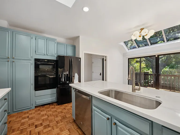 Quartz counters, breakfast bar, skylight, and a ton of storage and workspace.