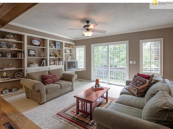 Den/study opens to kitchen and family room and provides doors to deck.