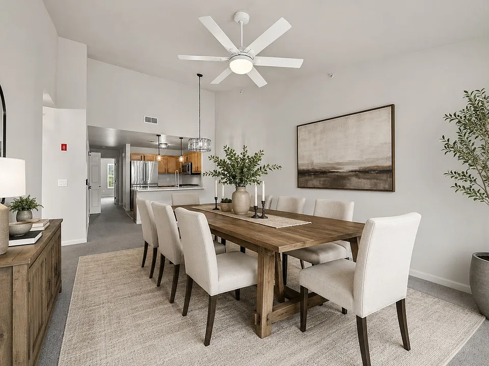 Virtually staged dining area showing one possible furniture layout and the open connection to the kitchen.