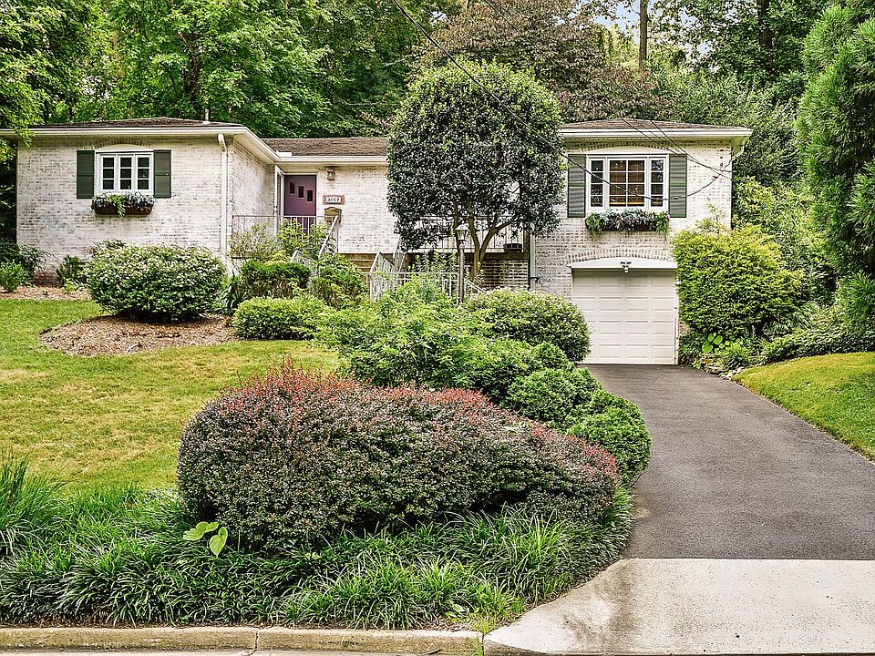 Front of house. Nice landscaping with lots of parking in garage, driveway and street. Stone paths on each side of the house leading to the backyard.