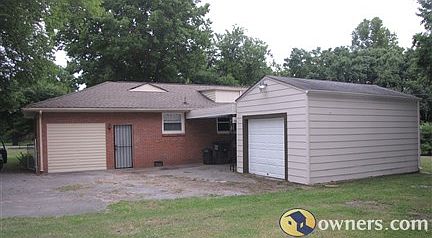 Rear view of house with carport and detached garage