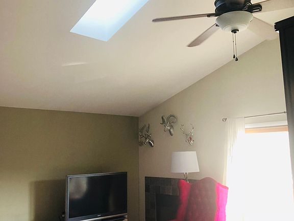 Living area with skylight and door to deck