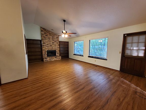 Living room with fireplace and view of the backyard