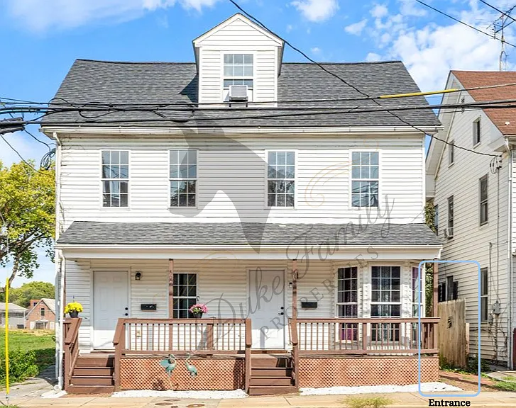Front of the triplex house. Note entrance to apartment outlined in light blue