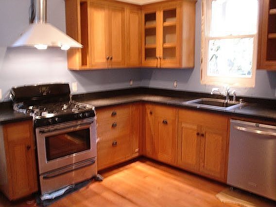 Kitchen: Stainless Range/DW/Fridge, custom cabinets, granite counter tops