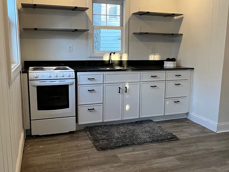 Light filled kitchen, granite counters. electric stove