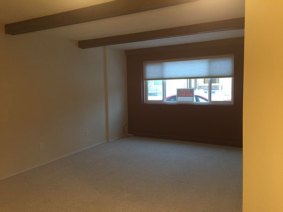 View from the dining area towards the living room and large window.
