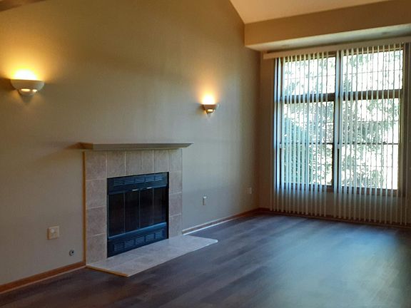 Large living room with vaulted ceiling and woodburning fireplace