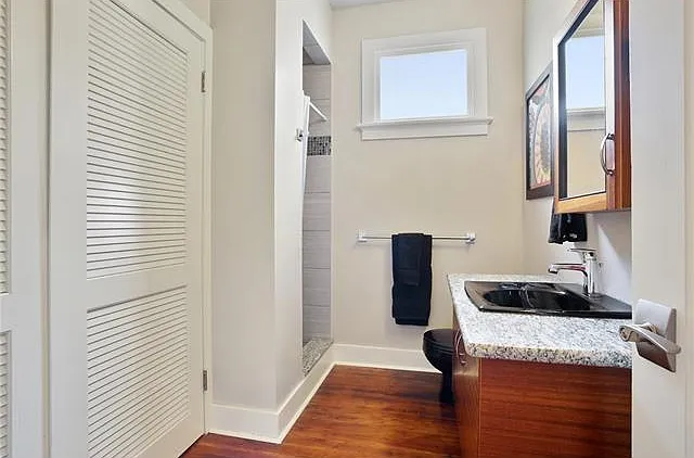 secondary bathroom with laundry closet