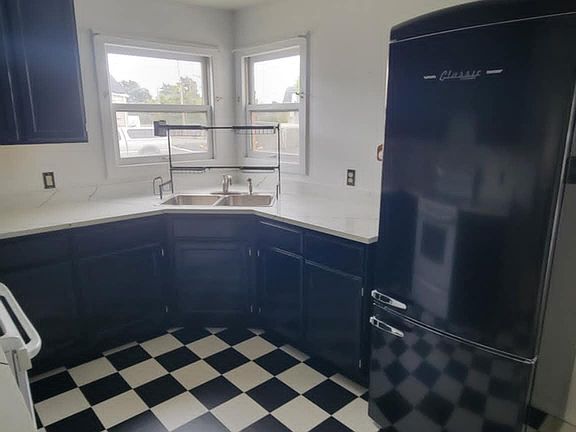 Completely remodeled kitchen: new counters, new flooring, new refrigerator, new sink, new light.
