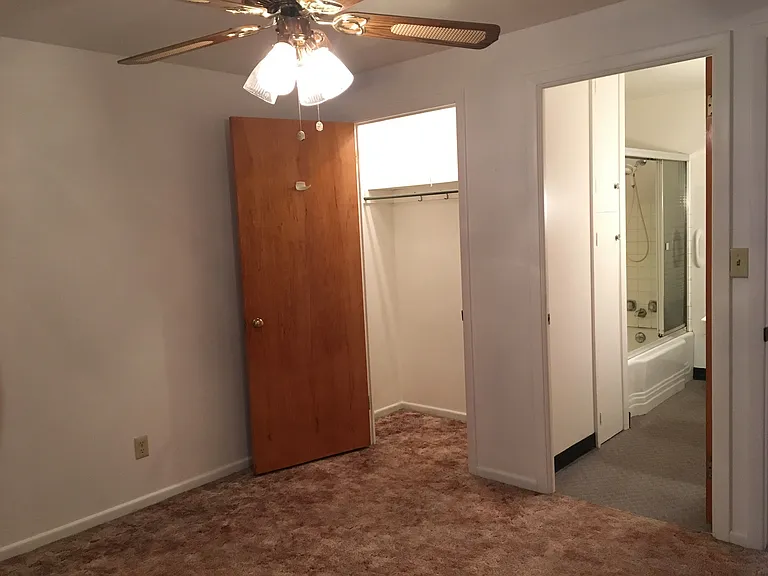 Bedroom closet, bathroom, and window to quiet rear yard,