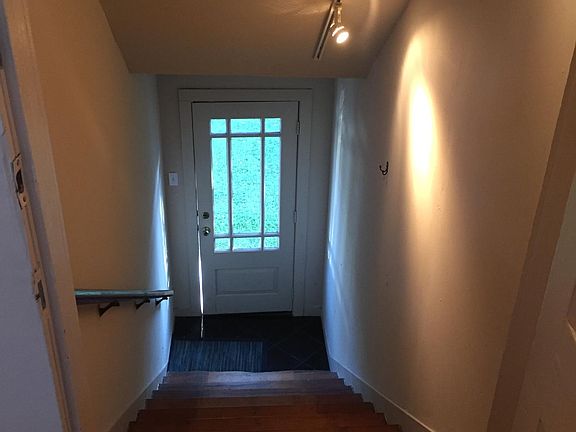 Stairs up to the garage apartment. Hallway features track li