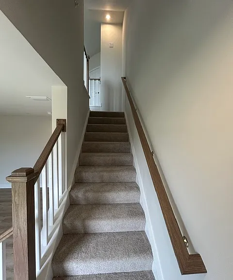 First floor rec room stairs to the living room kitchen 2nd floor