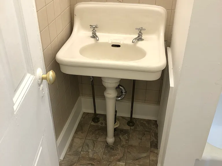 to left of sink is large bathroom closet for storage